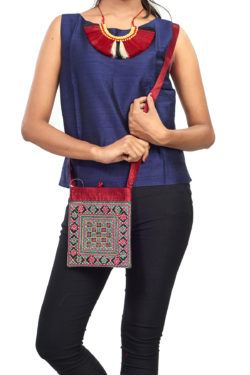 maroon evening bag with Gujarati embroidery and mirror work - close-up